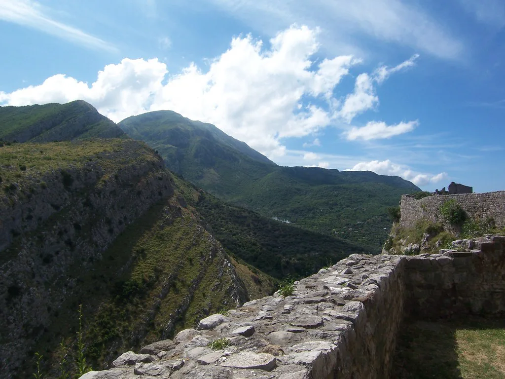 Old walls of Bar's old town above the mountains.