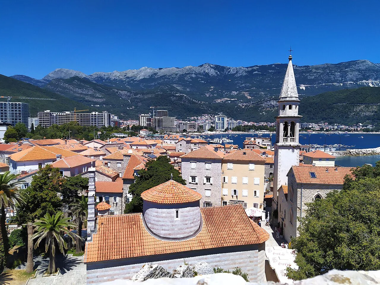 Budva Old Town rooftops and church bell tower seen from the citadel.
