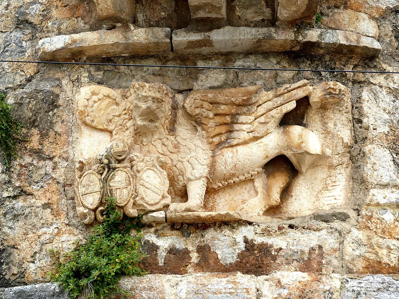A carved winged lion on Budva's Old Town walls.
