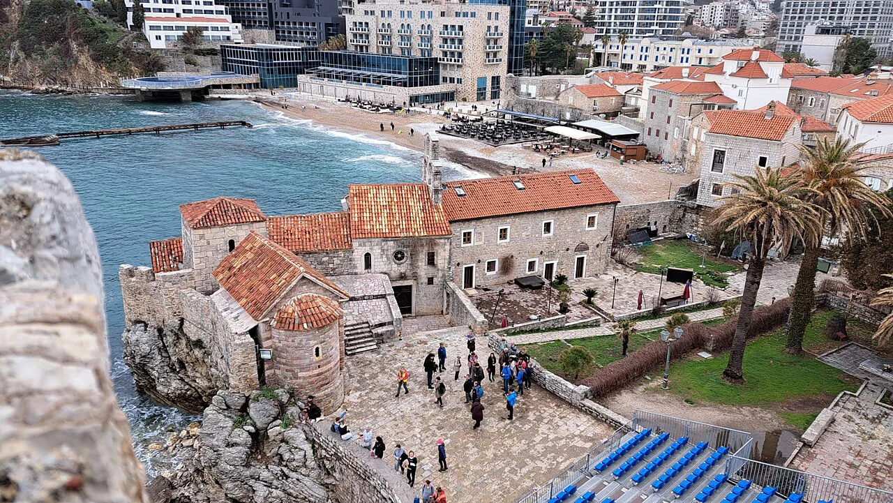 Stone houses and walls of Budva Old Town beside the sea.