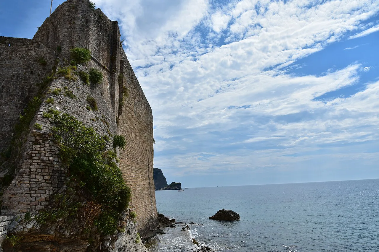 Budva's sea walls and rocky shoreline, near the Dancing Girl statue