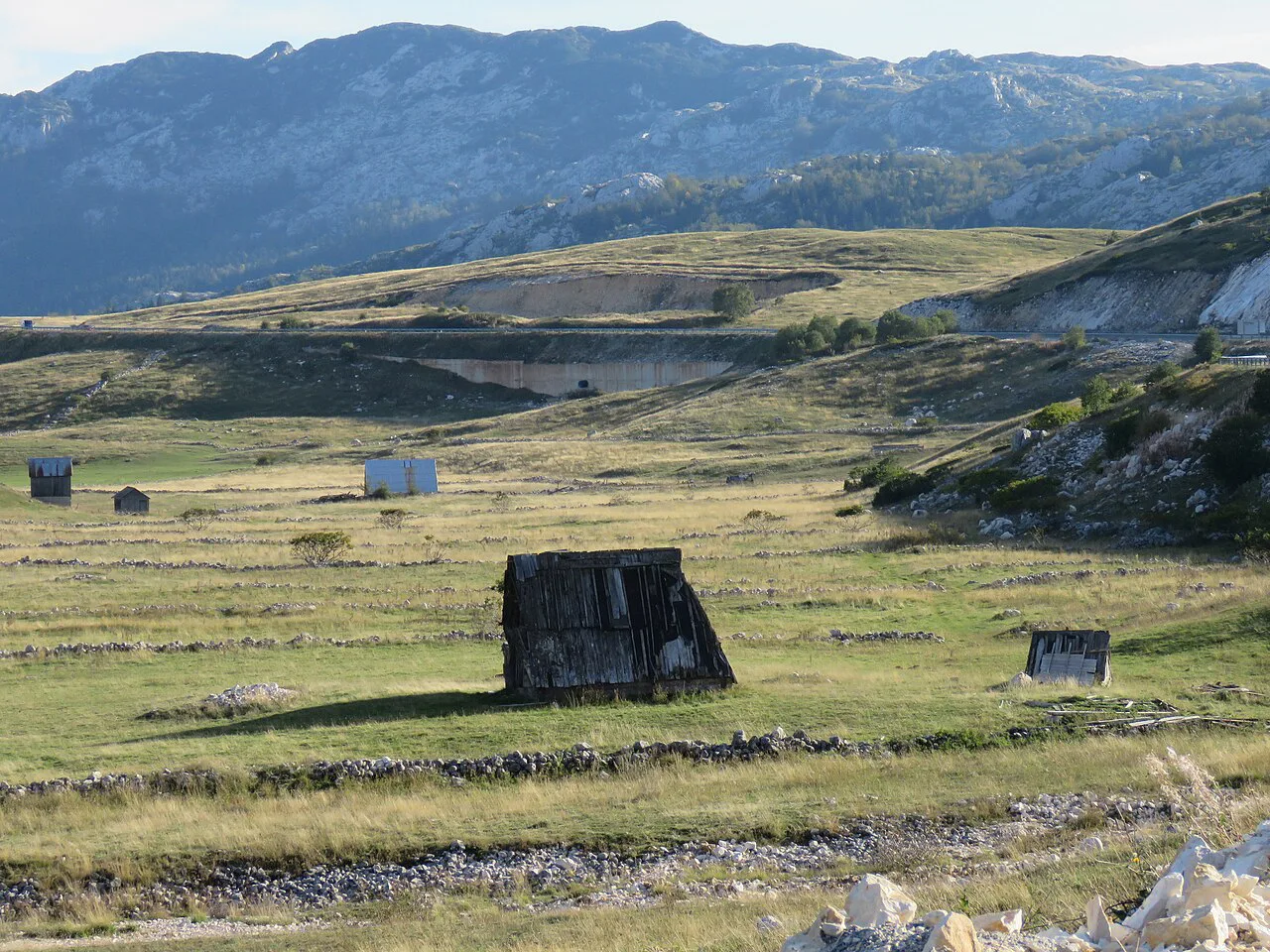 Fields and huts south of Žabljak with the Durmitor mountains behind.