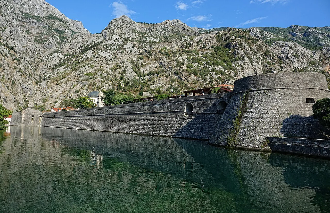 Kotor's old town walls reflected in the Škurda river.