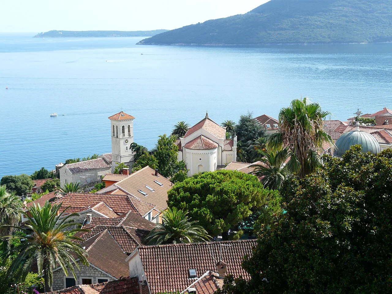 Herceg Novi's rooftops and church towers above the sea.
