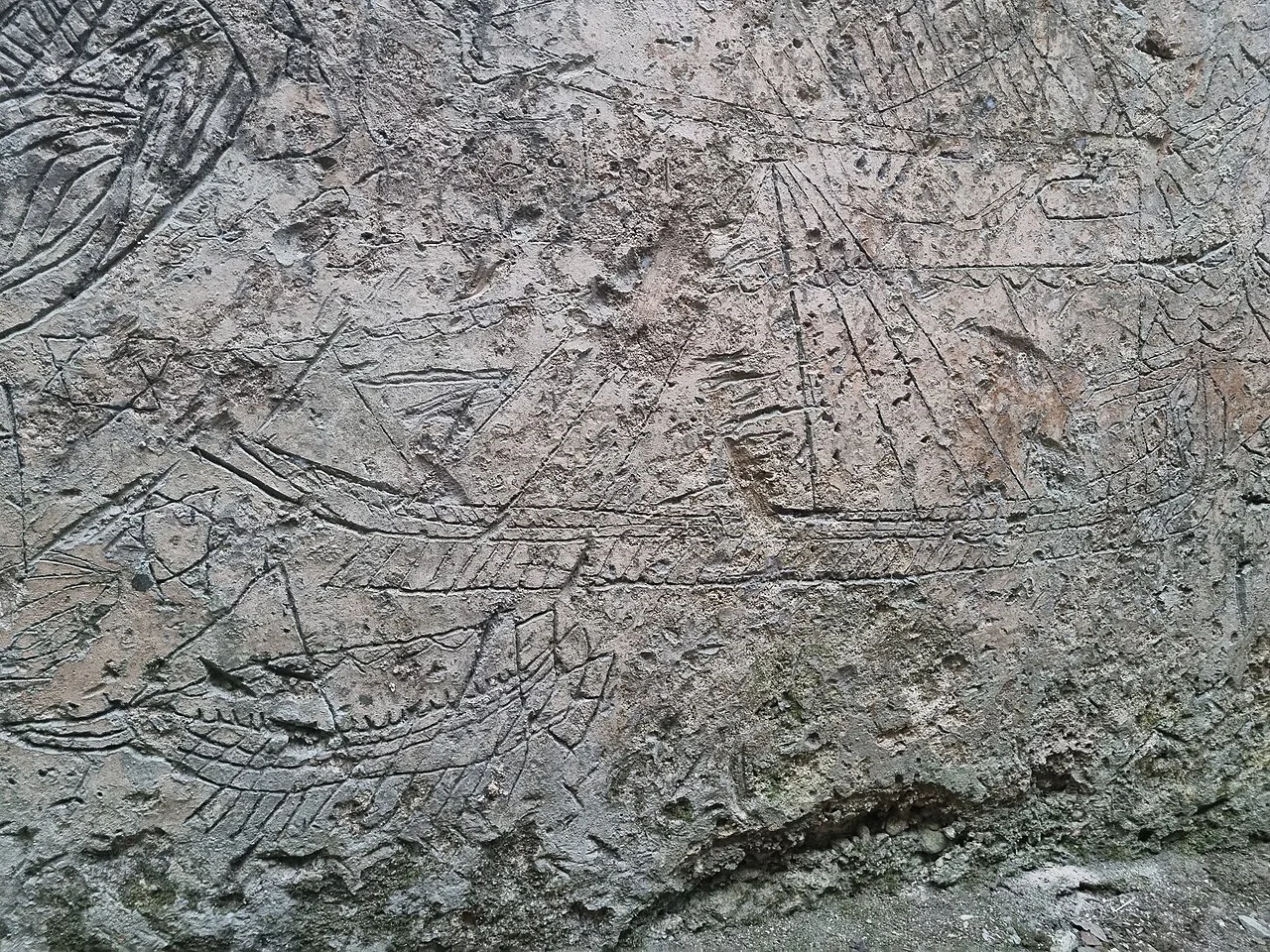 Ship drawings scratched by inmates into the walls of the former prison cistern at Kanli Kula.