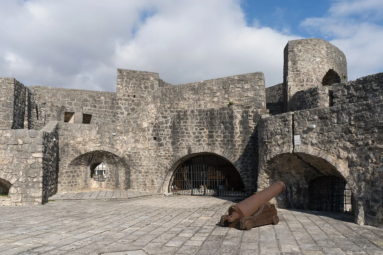 Stone walls and an old cannon inside Kanli Kula Fortress, Herceg Novi.