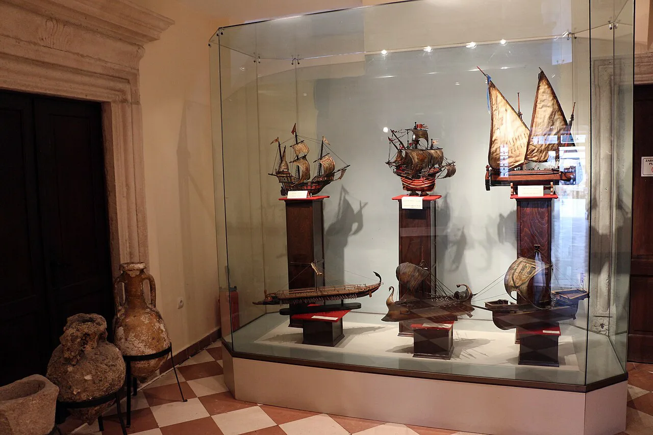 Historic ship models in a display case at the Maritime Museum in Kotor.