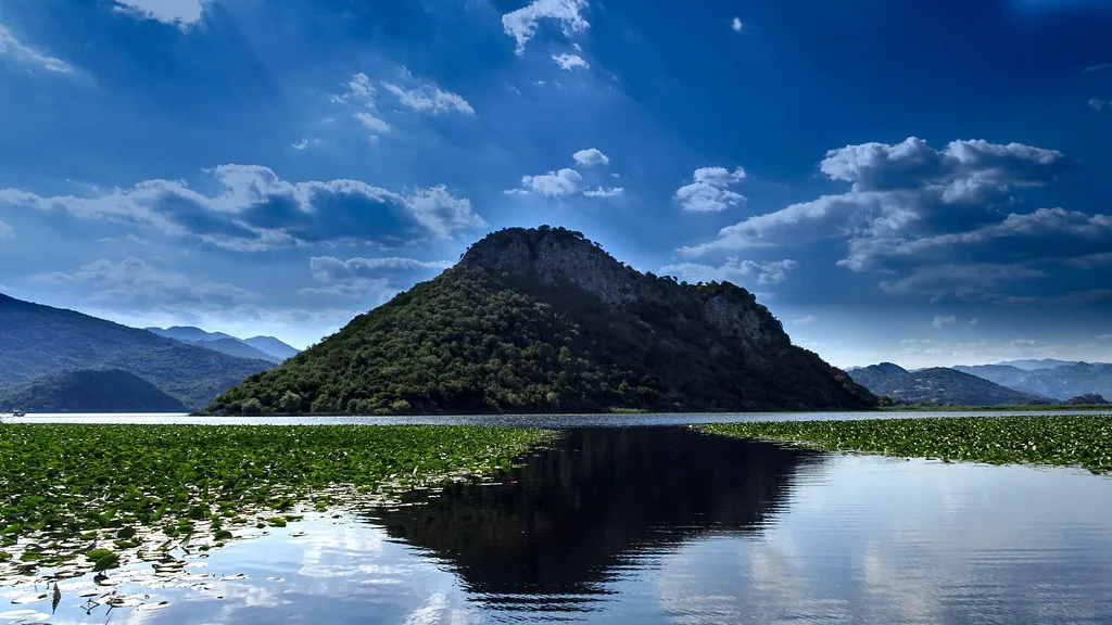 A hill reflected in Lake Skadar.