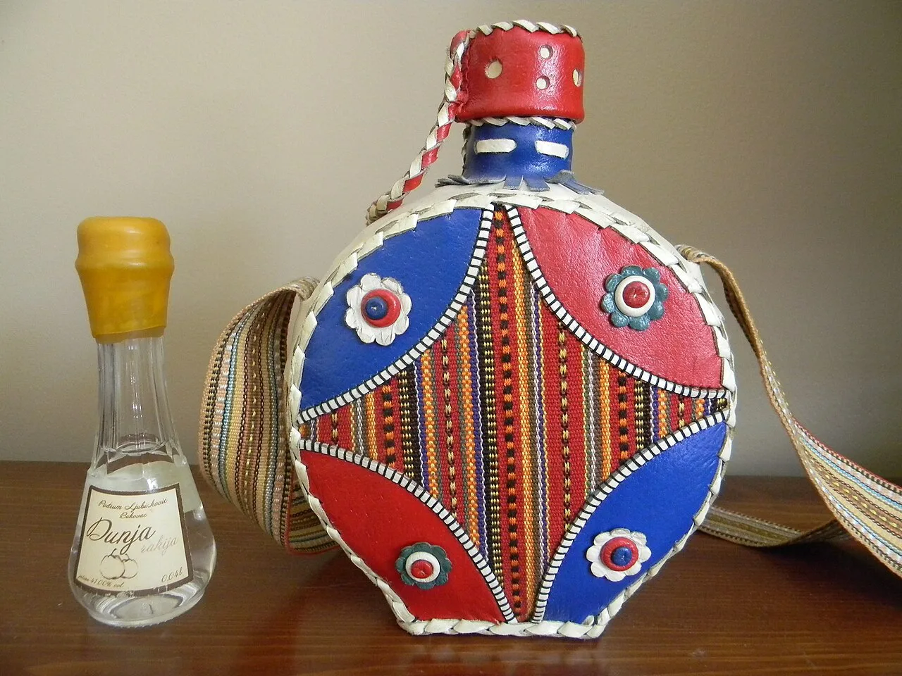 Quince rakija in a traditional decorated flask, from Serbia.