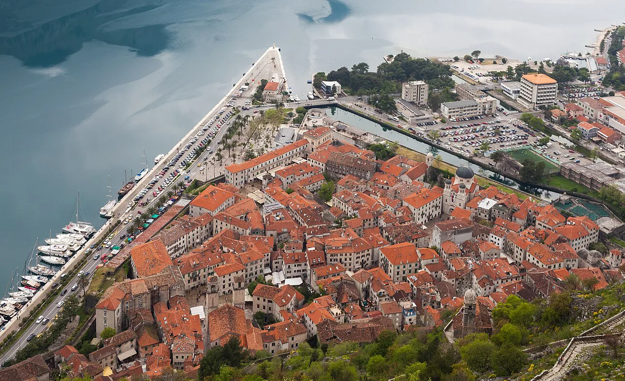 Aerial view of Kotor Old Town's rooftops and the bay.