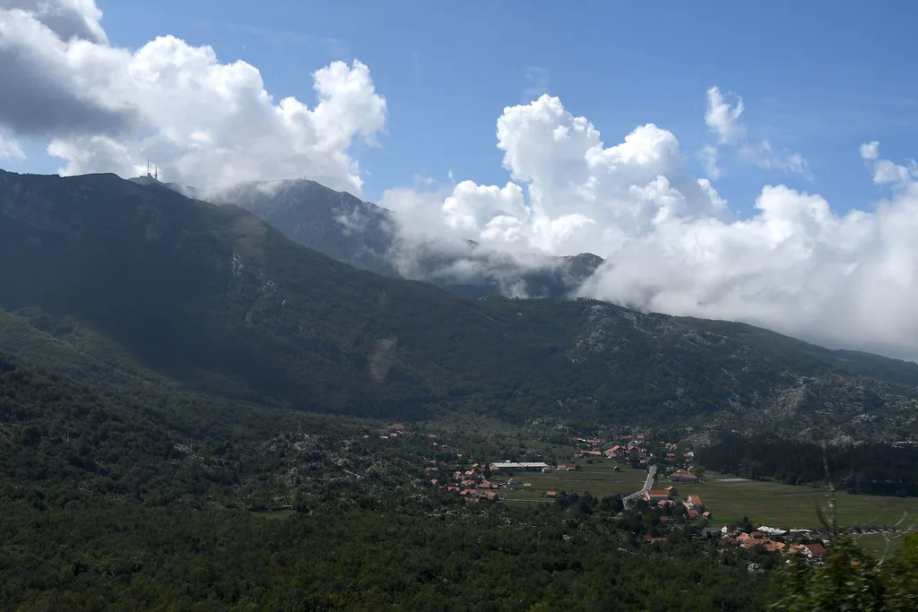 The valley at Njeguši beneath the mountains.