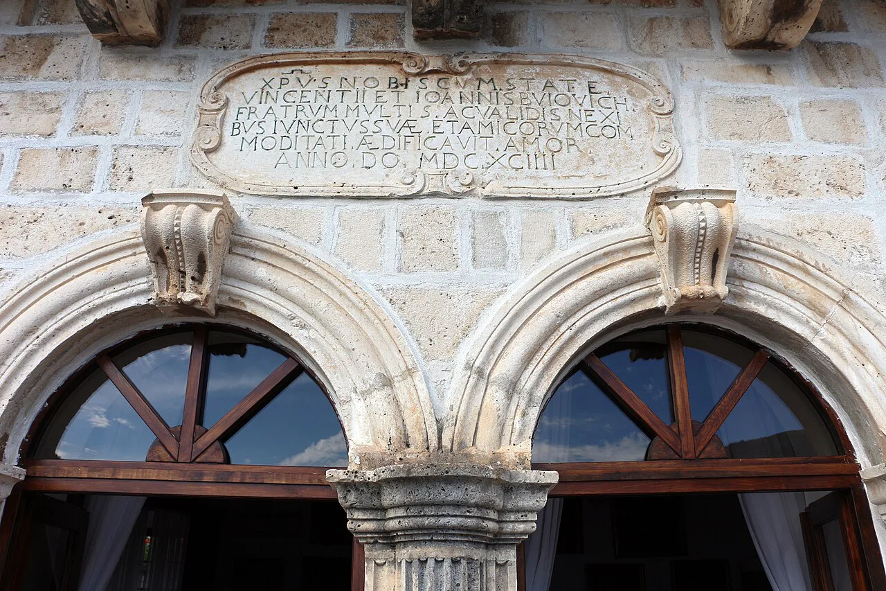 Carved inscription and arched windows on the terrace of the Bujović Palace, Perast Museum.