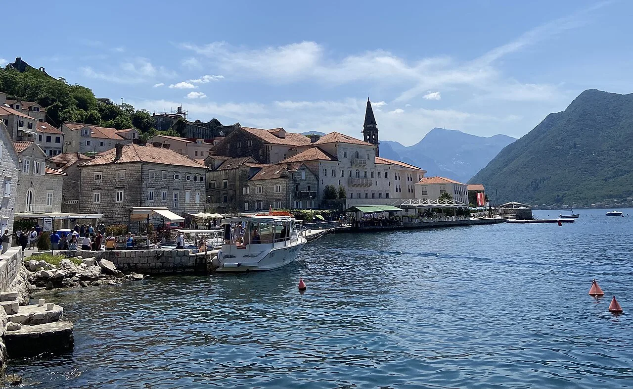 The Perast waterfront and church bell tower beside the Bay of Kotor.