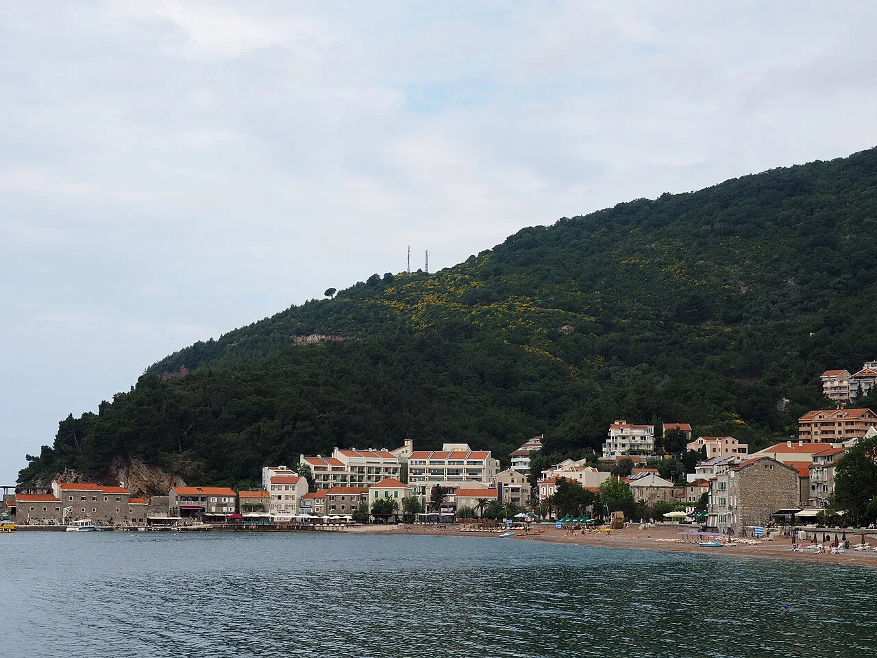 Petrovac seen from the sea beneath its wooded hills.