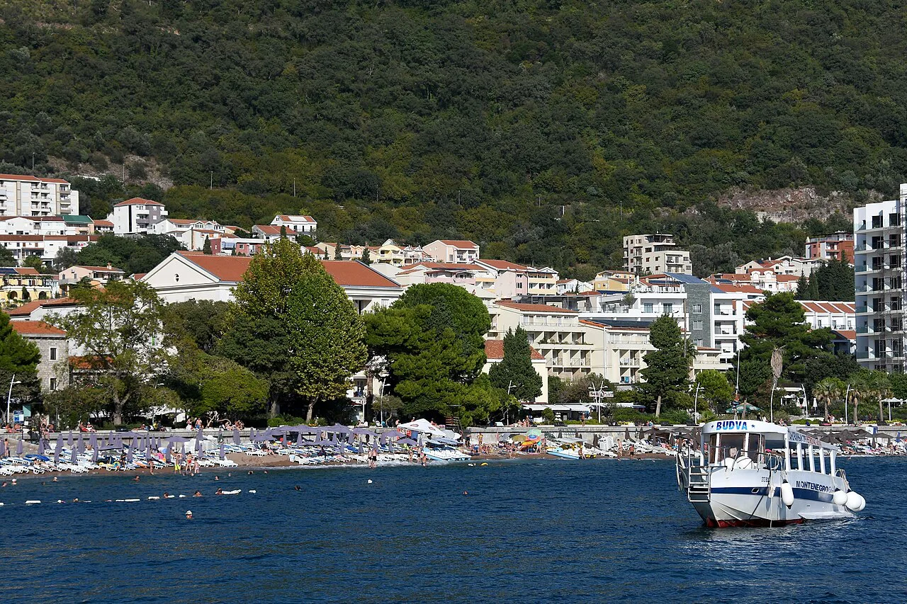 Petrovac's beach and town, backed by wooded hills.