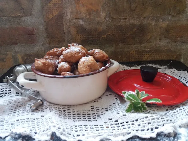Uštipci, fried dough balls similar to priganice, in an old pot.