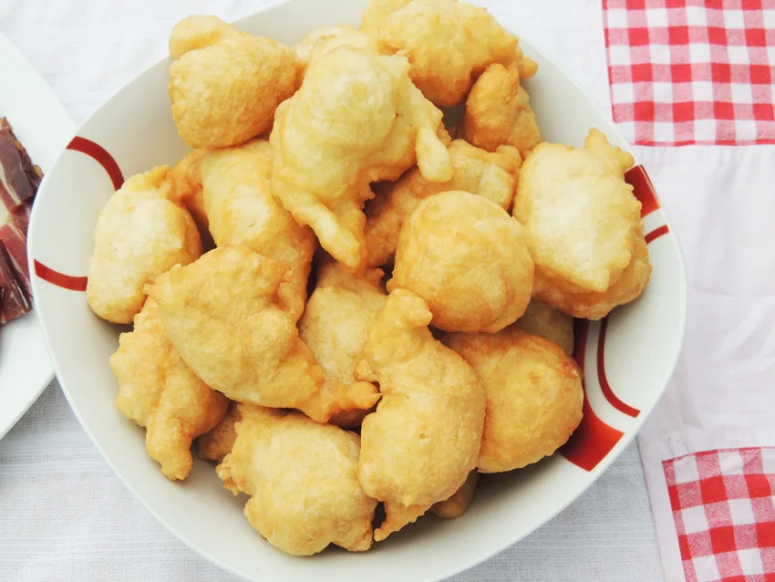 A plate of uštipci, the fried dough puffs also known as priganice.