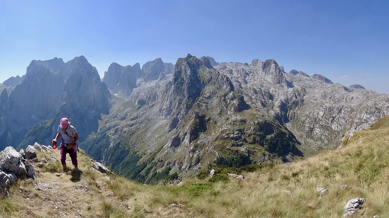 Hiker above the upper Grbaja valley, Prokletije, on the Peaks of the Balkans route.