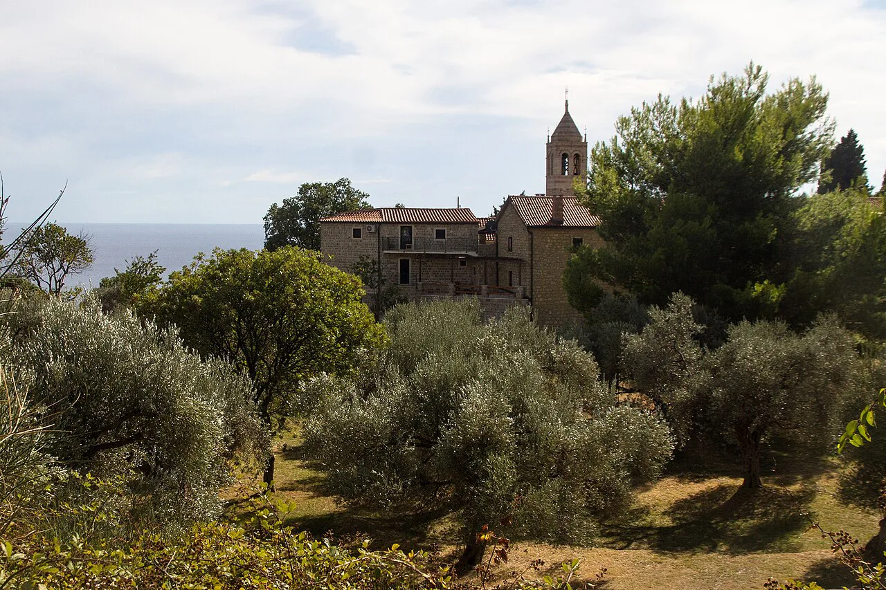 Reževići Monastery among olive and pine trees.