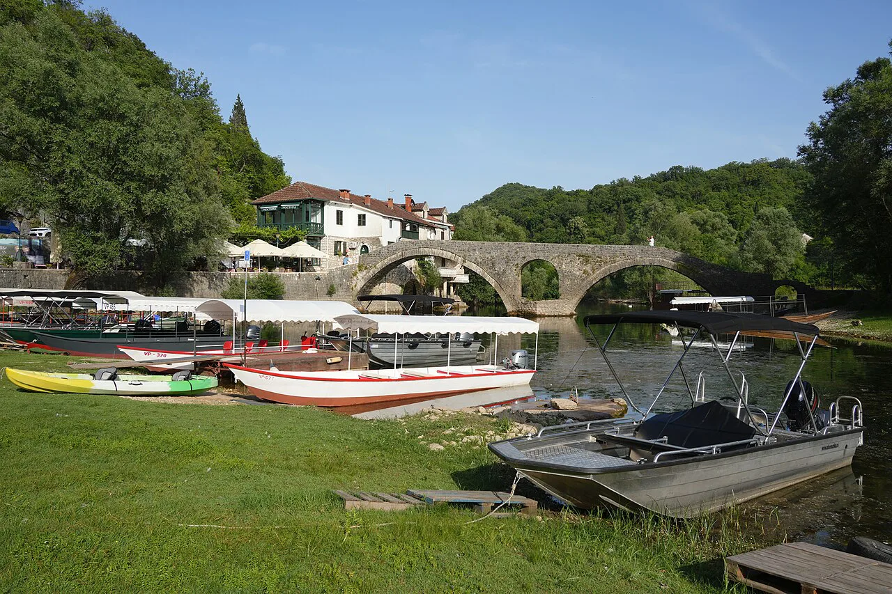 Boats moored by the old stone bridge at Rijeka Crnojevića.