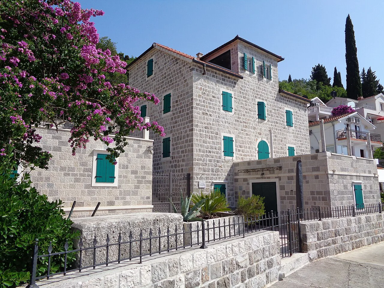 Stone houses and bougainvillea in Rose, Luštica.