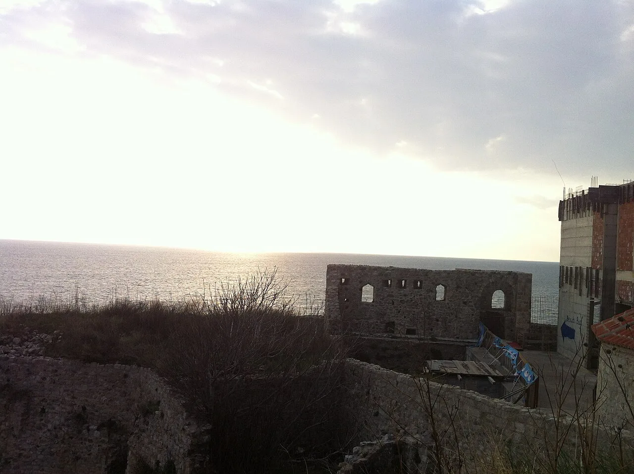 The walls of Ulcinj Old Town at sunset over the sea.