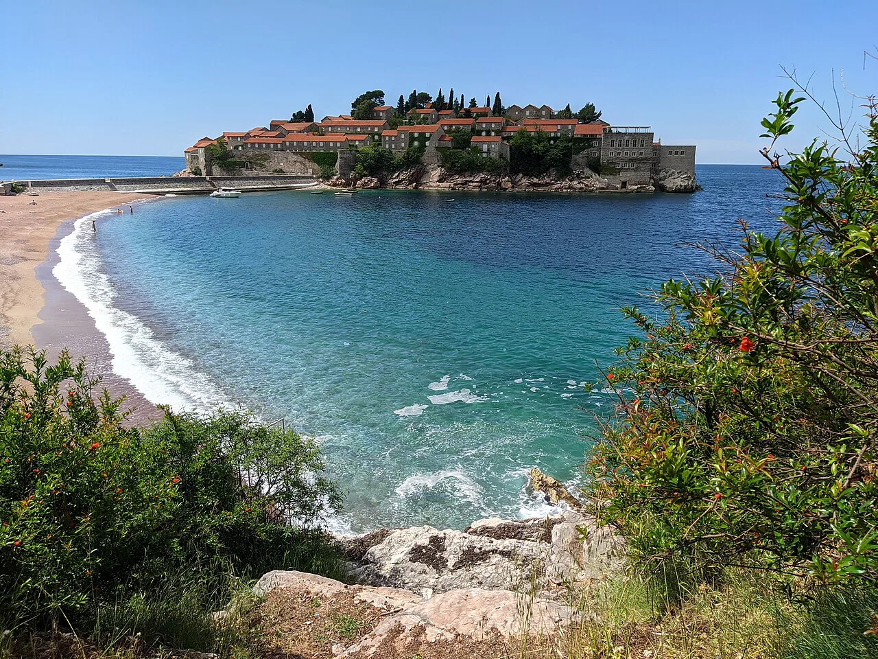 Sveti Stefan island and its curving beach seen from the coastal path.