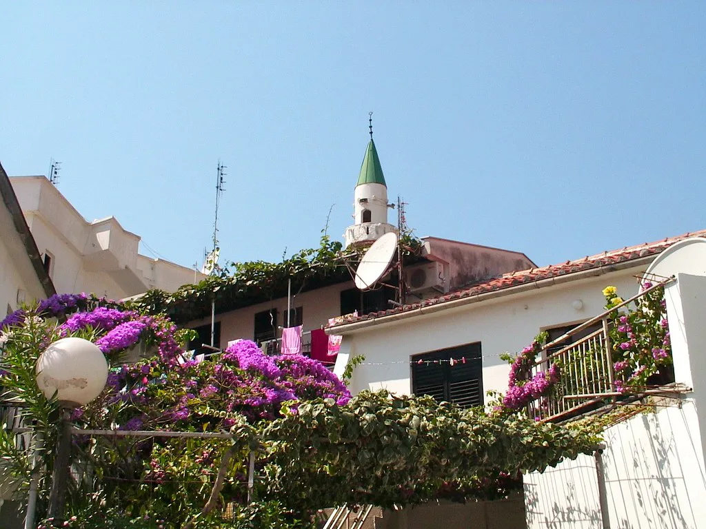 A flower-draped house and minaret in Ulcinj.