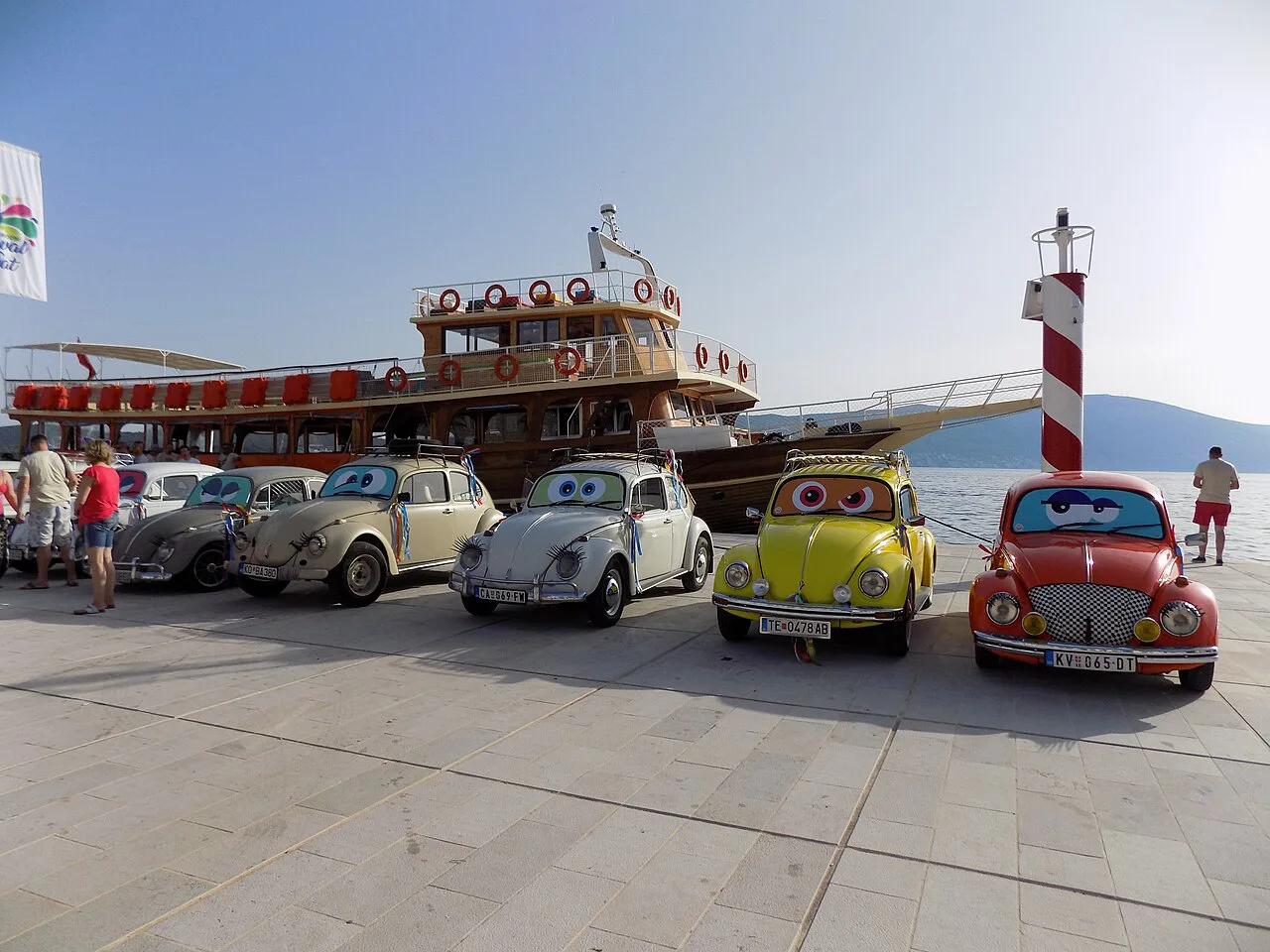 Volkswagen Beetles lined up on the Tivat waterfront during the 2019 carnival