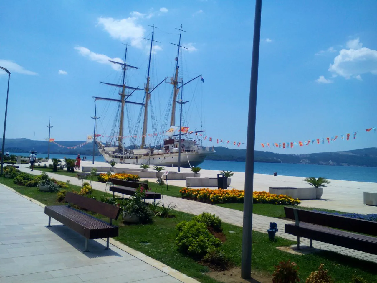 The Tivat Pine promenade with a tall ship moored alongside.