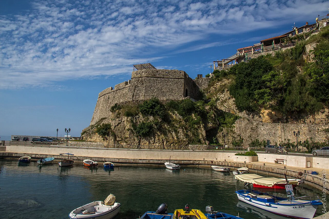 Small boats beneath the walls of Ulcinj Old Town.